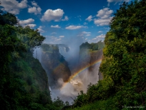 Regenbogen bij de Victoria watervallen in Zimbabwe